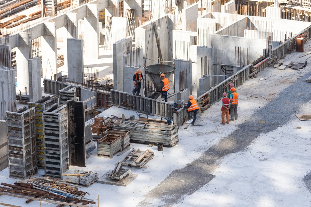 Construction,Worker,Concrete,Pouring,During,Commercial,Concreting,Floors,Of,Building
